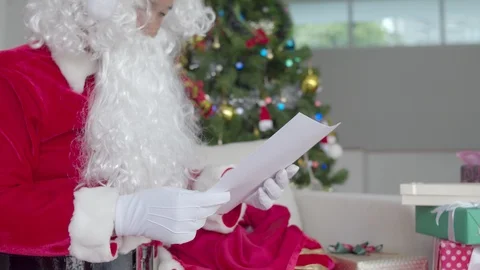 Santa Claus preparing to distribute present for children Stock Footage 119857932