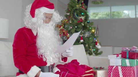Santa Claus preparing to distribute present for children Stock Footage 119858201