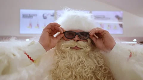 Santa Claus puts on glasses Stock Footage 228402995