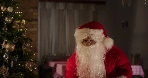 Santa Claus putting present under Christmas tree Stock Footage 167975182