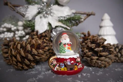 Santa Claus red globe with pine cones and Christmas decorations on background Stock Photos