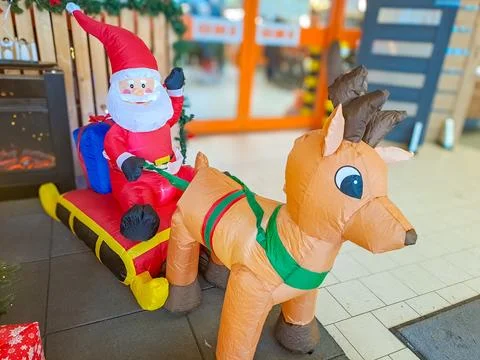 Santa Claus rides a sleigh pulled by a deer. Christmas tree toys. Czevh Stock Photos