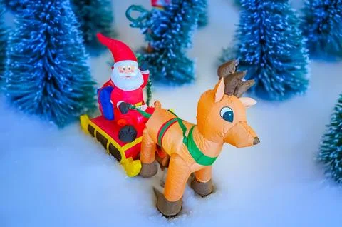 Santa Claus rides a sleigh pulled by a deer. Christmas tree toys. Czevh Stock Photos