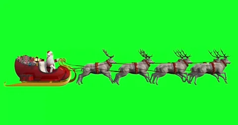 Santa Claus riding sleigh pulled by eight reindeer with gifts, representing Stock Footage 318003720
