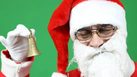 Santa Claus ringing a small bell on green background. Jingle Bells. Stock Footage 166319781