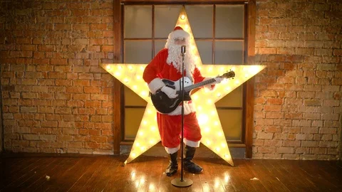 Santa Claus rock star, plays guitar, sings funny christmas songs in retro Stock Footage