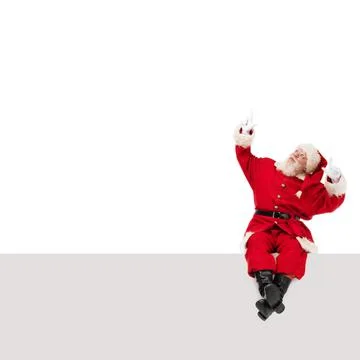 Santa Claus sitting on a blank panel Stock Photos