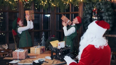 Santa Claus sitting at a table typing on an old typewriter. Stock Footage 118859969