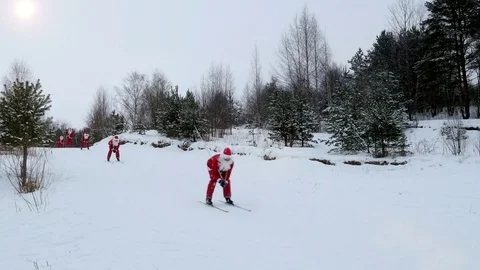 Santa Claus skiing down the hill in snowy forest, 4k footage Stock Footage 81736261