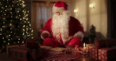 Santa Claus sorting letters in evening Stock Footage 167975615