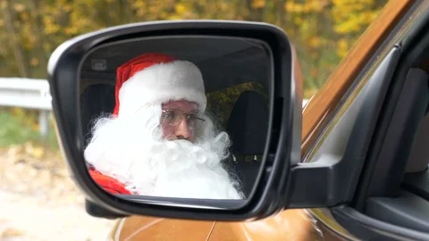 Santa Claus talking on the phone while sitting in the car 50 fps Stock Footage 81523232