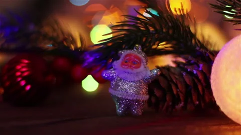 Santa claus toy pine tree  branch and christmas lights illumination new year Stock Footage 143551178