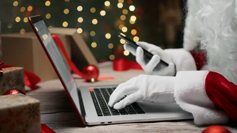 Santa Claus typing at Pc and scrolling smartphone Stock Footage 256012629