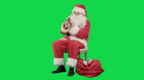 Santa Claus using tablet computer to surf internet and communicate in social Видео 56563148