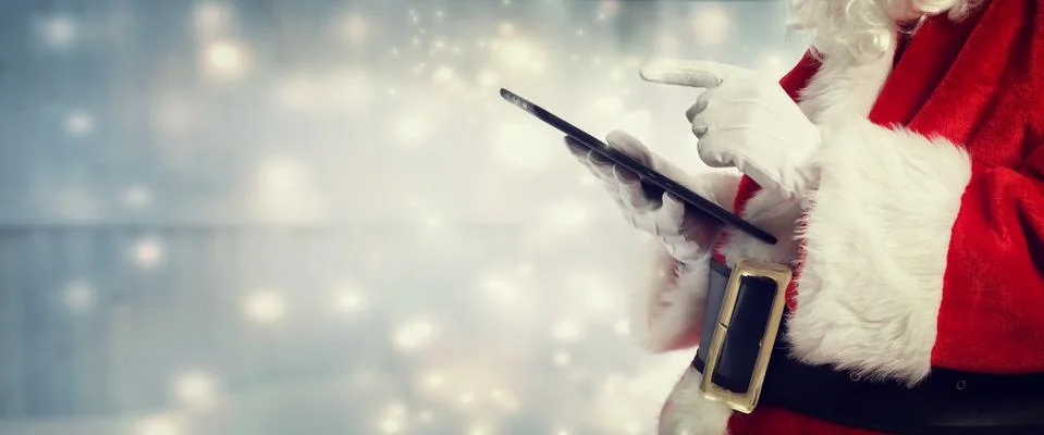 Santa Claus using a tablet Stock Photos