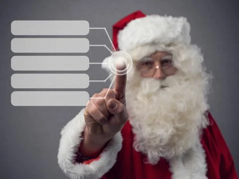 Santa Claus using a touch screen user interface Stock Photos