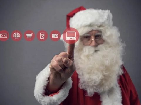 Santa Claus using a touch screen user interface Stock Photos