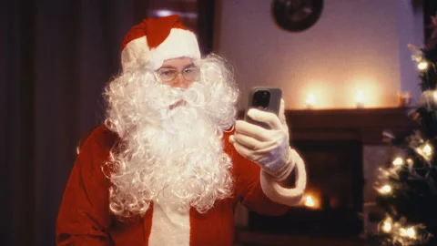 Santa claus video calling on a smartphone Stock Footage 345740072