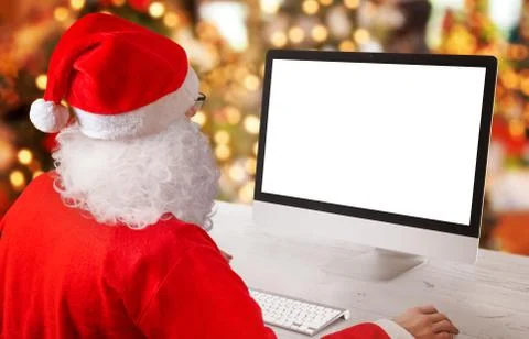 Santa Claus work on computer. Isolated, blank screen for mockup, app or web s Stock Photos