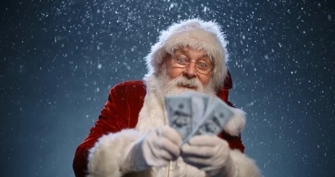 Santa clause looking at camera and showing packs of money in his hands, isolated Vídeos de archivo 114266359