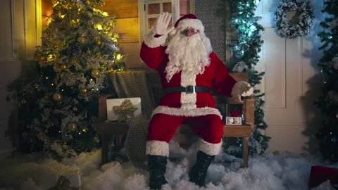 Santa Clause sitting next to shining and festive decorated Christmas tree wav Stock-Footage 252383079