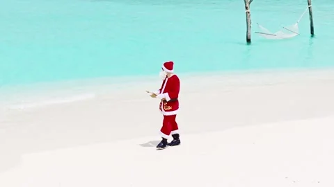 Santa Clause walk on the beach Stock Footage 254069515