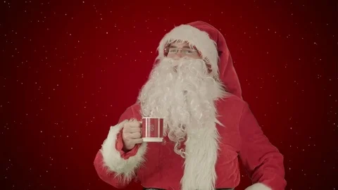 Santa drinks from a red cup on red background with snow Vídeos de archivo 70693393
