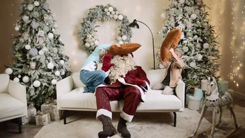 Santa enjoys slow motion fun with a child during a joyful New Year celebration Video stock 303698774