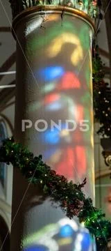 Santa Fe stained glass projected on cathedral white column at Christmas Stock Photos