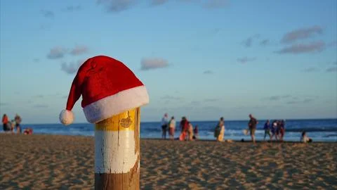 Santa hat on beach pole celebrating tropical Christmas holiday Stock Photos