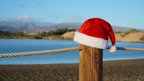 Santa hat on beach rope post celebrating Christmas holidays Stock Photos