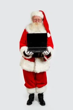Santa holding a notebook computer Stock Photos