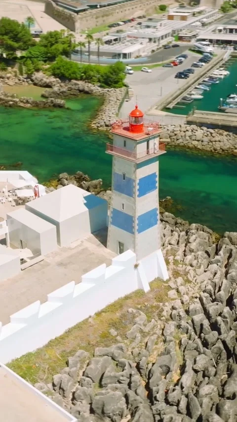 Santa Marta lighthouse and Cascais marina with Cascais cityscape, Portugal Stockbeeldmateriaal 344584378