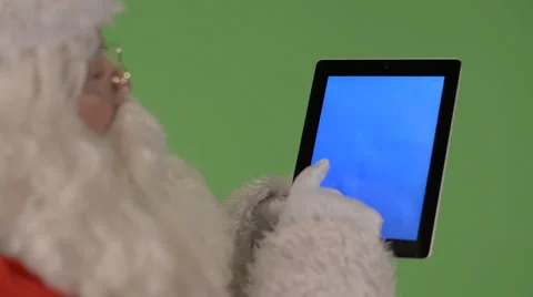 Santa playing with tablet Stock Footage 31813495