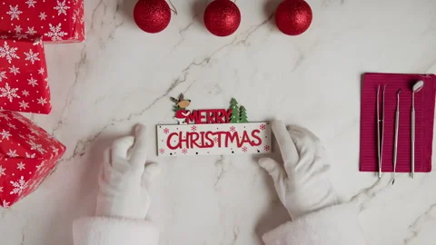 Santa putting Merry Christmas patch on white medical table Vídeos de archivo 255763674