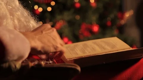 Santa reads a book 스톡 동영상 82020248