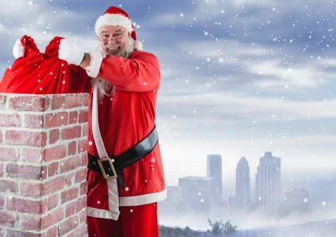 Santa removing gift sack from chimney Stock Photos