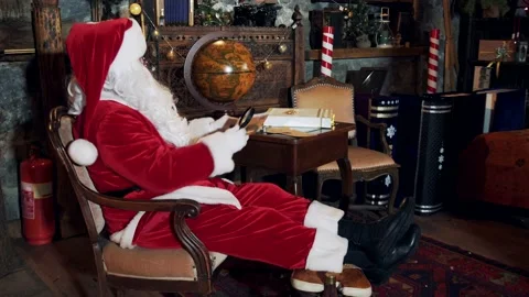 Santa is sitting at the table and reading letters. Stock Footage 166117092