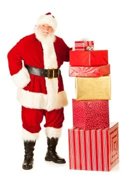 Santa: standing by large stack of gifts Stockfoto's