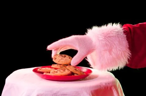 Santa taking cookie Stock Photos