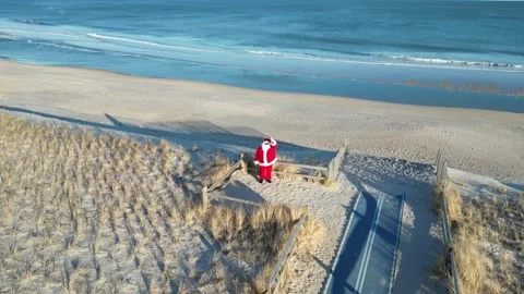 Santa Waves From the Beach 動画素材 228822348