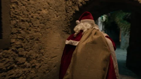 Santa Working outside with a bag full of presents Видео 255639354