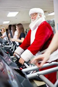 Santa workout  on a treadmill Stock Photos