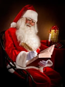 Santa Writes a Magic Feather in the Book Stock Photos