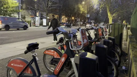 Santander Bikes with Bus Stop and Traffic at Night in London Video stock 332909838