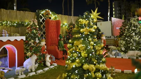 Santa's helper or elf sits on Santa's chair, celebrates Christmas. Child Video stock 117296019