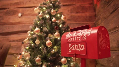 Santa's red mailbox, next to the decorated tree, with globes, cones and lights. Stock Footage 225476829