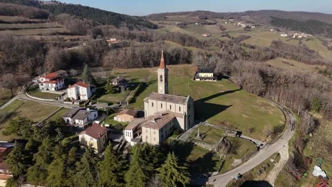 Santi Salvatore e Gallo bell tower rising above a quiet Morfasso village Stock Footage 327338481