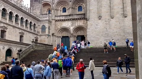 Santiago de Compostela, Spain - Jun 18, 2022: Pilgrims waiting for the mess Stock Footage 202983236