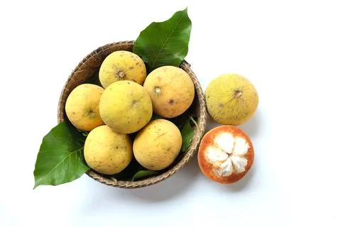 Santol fruit in a Wicker basket isolate on white background Stock Photos